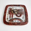 A pair of rectangular ceramic plates with a bird, signed._2