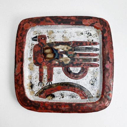 A pair of rectangular ceramic plates with a bird, signed.